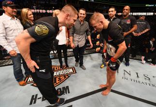 CHICAGO, IL - JULY 25: TJ Dillashaw (R) is congratulated by coach Duane Ludwig after his TKO victory over Renan Barao of Brazil in their UFC bantamweight championship bout during the UFC event at the United Center on July 25, 2015 in Chicago, Illinois.