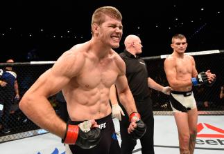 BRISBANE, AUSTRALIA - MARCH 20: (L-R) Jake Matthews of Australia celebrates after defeating Johnny Case of the United States by submission after their lightweight bout during the UFC Fight Night event at the Brisbane Entertainment Centre on March 20, 201
