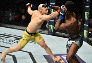 FRESNO, CA - DECEMBER 09: (L-R) Marlon Moraes of Brazil punches Aljamain Sterling in their bantamweight bout during the UFC Fight Night event inside Save Mart Center on December 9, 2017 in Fresno, California. (Photo by Jeff Bottari/Zuffa LLC/Zuffa LLC vi