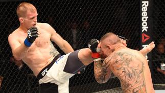 (L-R) Evan Dunham of the United States kicks Ross Pearson of England in their lightweight fight during the UFC Fight Night event inside the SSE Hydro on July 18, 2015 in Glasgow, Scotland. (Photo by Josh Hedges/Zuffa LLC/Zuffa LLC via Getty Images)