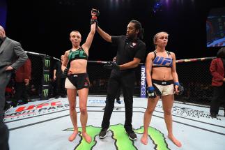 LAS VEGAS, NEVADA - DECEMBER 10: (L-R) Rose Namajunas celebrates her submission victory over Paige VanZant in their women's strawweight bout during the UFC Fight Night event at The Chelsea at the Cosmopolitan of Las Vegas on December 10, 2015 in Las Vega