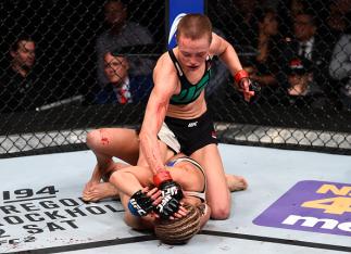 LAS VEGAS, NEVADA - DECEMBER 10: (Top) Rose Namajunas punches Paige VanZant in their women's strawweight bout during the UFC Fight Night event at The Chelsea at the Cosmopolitan of Las Vegas on December 10, 2015 in Las Vegas, Nevada. (Photo by Jeff Bott