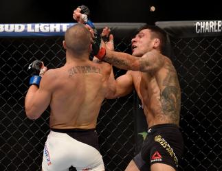 LAS VEGAS, NV - JULY 07: (L-R) Eddie Alvarez punches Rafael Dos Anjos of Brazil in their lightweight championship bout during the UFC Fight Night event inside the MGM Grand Garden Arena on July 7, 2016 in Las Vegas, Nevada. (Photo by Brandon Magnus/Zuff