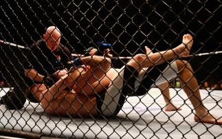 LONDON, ENGLAND - FEBRUARY 27: Teemu Packalen of Finland holds Thibault Gouti of France into submission to win the fight during the Lightweight Bout of the UFC Fight Night at The O2 Arena on February 27, 2016 in London, England. (Photo by Christopher L