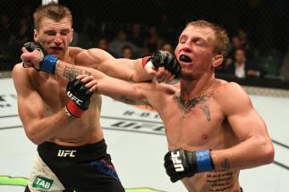 MELBOURNE, AUSTRALIA - NOVEMBER 27: (L-R) Dan Hooker of New Zealand and Jason Knight trade punches in their featherweight bout during the UFC Fight Night event at Rod Laver Arena on November 27, 2016 in Melbourne, Australia. (Photo by Jeff Bottari/Zuffa