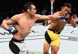 MEXICO CITY, MEXICO - NOVEMBER 05: (L-R) Tony Ferguson of the United States punches Rafael Dos Anjos of Brazil in their lightweight bout during the UFC Fight Night event at Arena Ciudad de Mexico on November 5, 2016 in Mexico City, Mexico. (Photo by Jeff