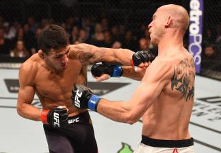 ORLANDO, FL - DECEMBER 19: (L-R) Rafael dos Anjos punches Donald Cerrone in their UFC lightweight title bout during the UFC Fight Night event at the Amway Center on December 19, 2015 in Orlando, Florida. (Photo by Josh Hedges/Zuffa LLC/Zuffa LLC via Get