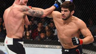 BOSTON, MA - JANUARY 17: (R-L) Patrick Cote of Canada punches Ben Saunders in their welterweight bout during the UFC Fight Night event inside TD Garden on January 17, 2016 in Boston, Massachusetts. (Photo by Jeff Bottari/Zuffa LLC/Zuffa LLC via Getty Ima