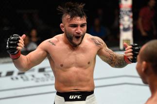 PORTLAND, OR - OCTOBER 01: (L-R) John Lineker of Brazil reacts to John Dodson in their bantamweight bout during the UFC Fight Night event at the Moda Center on October 1, 2016 in Portland, Oregon. (Photo by Josh Hedges/Zuffa LLC/Zuffa LLC via Getty Image