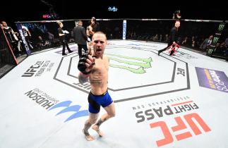 SACRAMENTO, CA - DECEMBER 17: (L-R) Eddie Wineland celebrates his victory over Takeya Mizugaki of Japan in their bantamweight bout during the UFC Fight Night event inside the Golden 1 Center Arena on December 17, 2016 in Sacramento, California. (Photo by