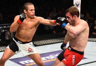 SACRAMENTO, CA - DECEMBER 17: (L-R) Urijah Faber punches Brad Pickett of England in their bantamweight bout during the UFC Fight Night event inside the Golden 1 Center Arena on December 17, 2016 in Sacramento, California. (Photo by Jeff Bottari/Zuffa LLC