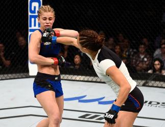 SACRAMENTO, CA - DECEMBER 17: (R-L) Michelle Waterson punches Paige VanZant in their women's strawweight bout during the UFC Fight Night event inside the Golden 1 Center Arena on December 17, 2016 in Sacramento, California. (Photo by Jeff Bottari/Zuffa L