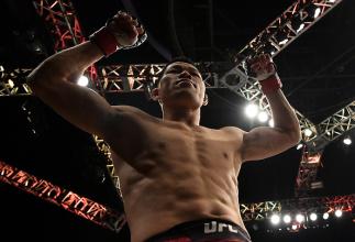 SHANGHAI, CHINA - NOVEMBER 25:  Li Jingliang of China celebrates after his knockout victory over Zak Ottow in their welterweight bout during the UFC Fight Night event inside the Mercedes-Benz Arena on November 25, 2017 in Shanghai, China. (Photo by Brando