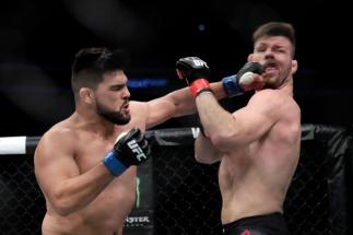 SHANGHAI, CHINA - NOVEMBER 25: (L-R) Kelvin Gastelum fights with Michael Bisping during the UFC Fight Night at Mercedes-Benz Arena on November 25, 2017 in Shanghai, China. (Photo by Hu Chengwei/Getty Images)