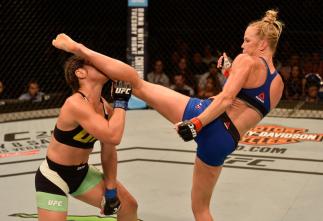 SINGAPORE - JUNE 17:   (R-L) Holly Holm knocks out Bethe Correia of Brazil with a kick in their women's bantamweight bout during the UFC Fight Night event at the Singapore Indoor Stadium on June 17, 2017 in Singapore. (Photo by Brandon Magnus/Zuffa LLC/Zu