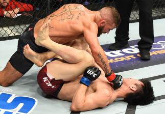 ST. LOUIS, MO - JANUARY 14:  (L-R) Jeremy Stephens punches Dooho Choi of South Korea in their featherweight bout during the UFC Fight Night event inside the Scottrade Center on January 14, 2018 in St. Louis, Missouri. (Photo by Josh Hedges/Zuffa LLC/Zuffa