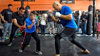 TAMPA, FL - APRIL 14: Glover Texeira of Brazil invites a fan to spar during an open workout for fans and media at Tigers World Gym on April 14, 2016 in Tampa, Florida. (Photo by Jeff Bottari/Zuffa LLC/Zuffa LLC via Getty Images)
