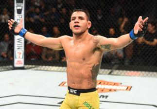 WINNIPEG, CANADA - DECEMBER 16: Rafael Dos Anjos of Brazil raises his hands after facing Robbie Lawler in their welterweight bout during the UFC Fight Night event at Bell MTS Place on December 16, 2017 in Winnipeg, Manitoba, Canada. (Photo by Josh Hedges