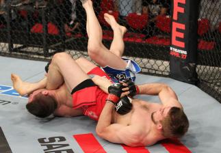 SYDNEY, AUSTRALIA - MARCH 03: (R-L) TJ Waldburger secures an arm bar submission against Jake Hecht in their welterweight bout during the UFC on FX event at Allphones Arena on March 3, 2012 in Sydney, Australia. (Photo by Josh Hedges/Zuffa LLC/Zuffa LLC