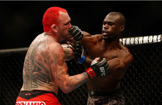 LAS VEGAS, NV - DECEMBER 28: (R-L) Uriah Hall punches Chris Leben in their middleweight bout during the UFC 168 event at the MGM Grand Garden Arena on December 28, 2013 in Las Vegas, Nevada. (Photo by Josh Hedges/Zuffa LLC/Zuffa LLC via Getty Images) ***