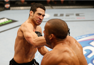 SACRAMENTO, CA - DECEMBER 14: (L-R) Danny Castillo punches Edson Barboza in their lightweight bout during the UFC on FOX event at Sleep Train Arena on December 14, 2013 in Sacramento, California. (Photo by Josh Hedges/Zuffa LLC/Zuffa LLC via Getty Images