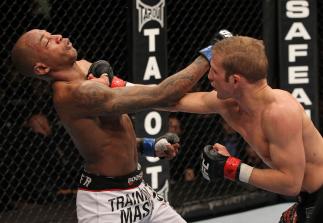 OMAHA, NE - FEBRUARY 15: (R-L) TJ Dillashaw punches Walel Watson during the UFC on FUEL TV event at Omaha Civic Auditorium on February 15, 2012 in Omaha, Nebraska. (Photo by Josh Hedges/Zuffa LLC/Zuffa LLC via Getty Images) *** Local Caption *** TJ Dill