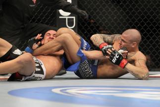 LAS VEGAS, NV - FEBRUARY 04: Dustin Poirier (blue shorts) attempts to submit Max Holloway during the UFC 143 event at Mandalay Bay Events Center on February 4, 2012 in Las Vegas, Nevada. (Photo by Josh Hedges/Zuffa LLC/Zuffa LLC via Getty Images) *** Lo