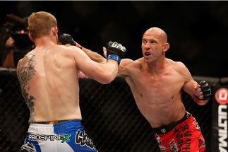 LAS VEGAS, NV - NOVEMBER 16:  (R-L) Donald Cerrone punches Evan Dunham in their lightweight bout during the UFC 167 event inside the MGM Grand Garden Arena on November 16, 2013 in Las Vegas, Nevada. (Photo by Josh Hedges/Zuffa LLC/Zuffa LLC via Getty Imag