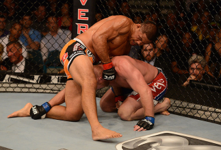 LAS VEGAS, NV - JULY 06: Mark Munoz (top) punches Tim Boetsch in their middleweight fight during the UFC 162 event inside the MGM Grand Garden Arena on July 6, 2013 in Las Vegas, Nevada. (Photo by Donald Miralle/Zuffa LLC/Zuffa LLC via Getty Images) ***