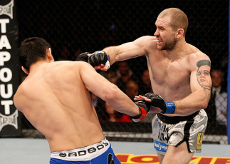 LAS VEGAS, NV - DECEMBER 29: (R-L) Alan Belcher punches Yushin Okami during their middleweight fight at UFC 155 on December 29, 2012 at MGM Grand Garden Arena in Las Vegas, Nevada. (Photo by Josh Hedges/Zuffa LLC/Zuffa LLC via Getty Images) *** Local Cap