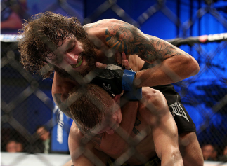 FORT CAMPBELL, KENTUCKY - NOVEMBER 6: Michael Chiesa (top) attempts to submit Colton Smith in their UFC lightweight bout on November 6, 2013 in Fort Campbell, Kentucky. (Photo by Ed Mulholland/Zuffa LLC/Zuffa LLC via Getty Images) *** Local Caption ***Co