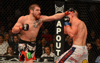 LAS VEGAS, NV - DECEMBER 29: (L-R) Jim Miller punches Joe Lauzon during their lightweight fight at UFC 155 on December 29, 2012 at MGM Grand Garden Arena in Las Vegas, Nevada. (Photo by Donald Miralle/Zuffa LLC/Zuffa LLC via Getty Images) *** Local Capti