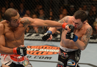 LAS VEGAS, NV - FEBRUARY 02: (L-R) Jose Aldo punches Frankie Edgar during their featherweight title fight at UFC 156 on February 2, 2013 at the Mandalay Bay Events Center in Las Vegas, Nevada. (Photo by Donald Miralle/Zuffa LLC/Zuffa LLC via Getty Image