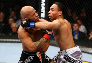 CHICAGO, IL - JANUARY 26: John Dodson (R) punches Demetrious Johnson (L) during thier Flyweight Championship Bout part of UFC on FOX at United Center on January 26, 2013 in Chicago, Illinois. (Photo by Al Bello/Zuffa LLC/Zuffa LLC Via Getty Images)