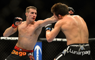 SEATTLE, WA - JULY 27: (L-R) Rory MacDonald punches Jake Ellenberger in their welterweight bout during the UFC on FOX event at Key Arena on July 27, 2013 in Seattle, Washington. (Photo by Jeff Bottari/Zuffa LLC/Zuffa LLC via Getty Images) *** Local Captio