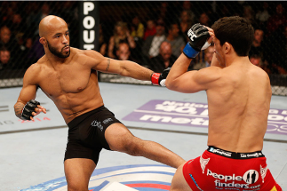 SACRAMENTO, CA - DECEMBER 14: (L-R) Demetrious Johnson kicks Joseph Benavidez in their flyweight championship bout during the UFC on FOX event at Sleep Train Arena on December 14, 2013 in Sacramento, California. (Photo by Josh Hedges/Zuffa LLC/Zuffa LLC