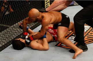 SACRAMENTO, CA - DECEMBER 14: Demetrious Johnson (top) punches Joseph Benavidez in their flyweight championship bout during the UFC on FOX event at Sleep Train Arena on December 14, 2013 in Sacramento, California. (Photo by Josh Hedges/Zuffa LLC/Zuffa LL