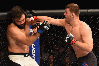LAS VEGAS, NV - JANUARY 02: (R-L) Stipe Miocic punches Andrei Arlovski in their heavyweight bout during the UFC 195 event inside MGM Grand Garden Arena on January 2, 2016 in Las Vegas, Nevada. (Photo by Josh Hedges/Zuffa LLC/Zuffa LLC via Getty Images)