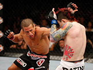 LAS VEGAS, NV - APRIL 13: (L-R) Urijah Faber punches Scott Jorgensen in their bantamweight fight at the Mandalay Bay Events Center on April 13, 2013 in Las Vegas, Nevada. (Photo by Josh Hedges/Zuffa LLC/Zuffa LLC via Getty Images) *** Local Caption *