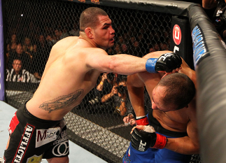 LAS VEGAS, NV - DECEMBER 29: (L-R) Cain Velasquez punches Junior dos Santos during their heavyweight championship fight at UFC 155 on December 29, 2012 at MGM Grand Garden Arena in Las Vegas, Nevada. (Photo by Josh Hedges/Zuffa LLC/Zuffa LLC via Getty Im