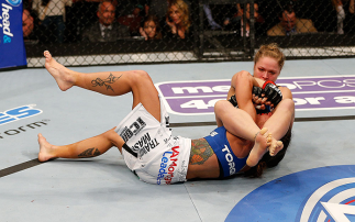 ANAHEIM, CA - FEBRUARY 23:  Ronda Rousey (right) attempts to submit Liz Carmouche in their women's bantamweight title fight during UFC 157 at Honda Center on February 23, 2013 in Anaheim, California.  (Photo by Josh Hedges/Zuffa LLC/Zuffa LLC via Getty Im