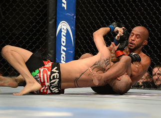 SEATTLE, WA - JULY 27: Demetrious Johnson (right) attempts to submit John Moraga in their flyweight championship bout during the UFC on FOX event at Key Arena on July 27, 2013 in Seattle, Washington. (Photo by Jeff Bottari/Zuffa LLC/Zuffa LLC via Getty Im