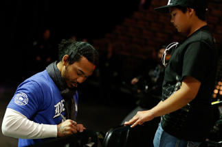 LAS VEGAS, NV - FEBRUARY 01: UFC lightweight champion Benson Henderson signs an autograph for a young fan during a Q&A session before the UFC 156 weigh-in on February 1, 2013 at Mandalay Bay Events Center in Las Vegas, Nevada. (Photo by Josh Hedges/Zuff