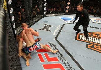 LAS VEGAS, NV - JUNE 01: Martin Kampmann (blue shorts) attempts to finish Jake Ellenberger as referee Steve Mazzagatti (right) observes in a Welterweight bout during The Ultimate Fighter Live Finale at the Pearl Theater at the Palms Casino Resort on Jun