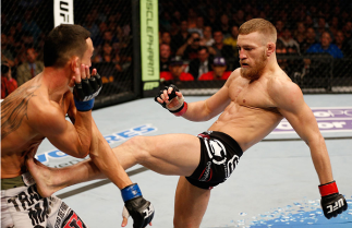 BOSTON, MA - AUGUST 17: (R-L) Conor McGregor kicks Max Holloway in their UFC featherweight bout at TD Garden on August 17, 2013 in Boston, Massachusetts. (Photo by Josh Hedges/Zuffa LLC/Zuffa LLC via Getty Images)