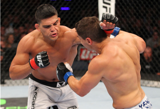 INDIANAPOLIS, IN - AUGUST 28: (L-R) Kelvin Gastelum punches Brian Melancon in their welterweight fight during the UFC on FOX Sports 1 event at Bankers Life Fieldhouse on August 28, 2013 in Indianapolis, Indiana. (Photo by Ed Mulholland/Zuffa LLC/Zuffa LL