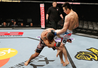 SAITAMA, JAPAN - MARCH 03: (R-L) Hyun Gyu Lim knees Marcelo Guimaraes in their welterweight fight during the UFC on FUEL TV event at Saitama Super Arena on March 3, 2013 in Saitama, Japan. (Photo by Josh Hedges/Zuffa LLC/Zuffa LLC via Getty Images)