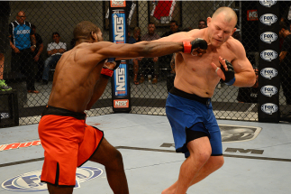 LAS VEGAS, NV - OCTOBER 16: (L-R) Corey Anderson punches Kelly Anundson in their elimination fight during filming of season nineteen of The Ultimate Fighter on October 16, 2013 in Las Vegas, Nevada. (Photo by Al Powers/Zuffa LLC/Zuffa LLC via Getty Image