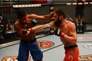 LAS VEGAS, NV - OCTOBER 16: (R-L) Adam Stroup exchanges punches with Dhiego Lima in their elimination fight during filming of season nineteen of The Ultimate Fighter on October 16, 2013 in Las Vegas, Nevada. (Photo by Al Powers/Zuffa LLC/Zuffa LLC via Ge