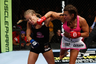 SAN DIEGO, CA - AUGUST 18:  (R-L) Miesha Tate punches Julie Kedzie during the Strikeforce event at Valley View Casino Center on August 18, 2012 in San Diego, California. (Photo by Esther Lin/Forza LLC/Forza LLC via Getty Images)